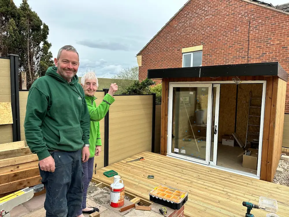 Garden room customer and installer part way through the build